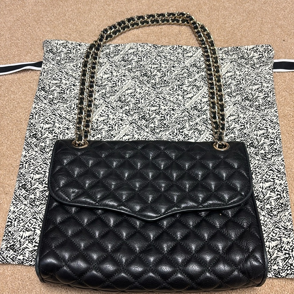 Rebecca Minkoff bag. Used but like new black quilted adjustable strap bag.